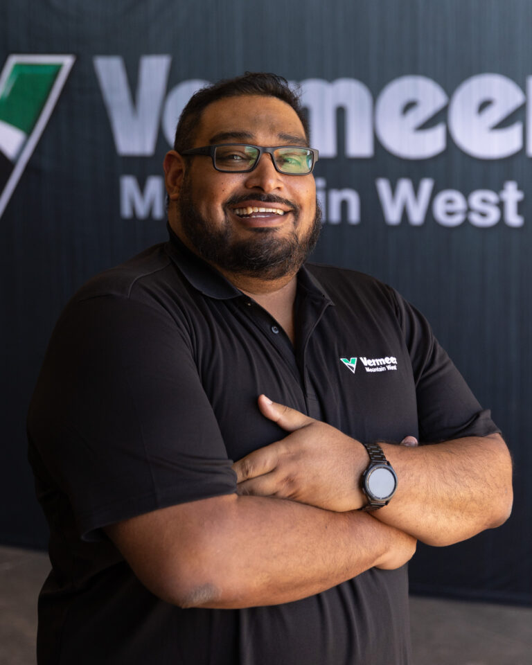 Alan Saenz, Vermeer Equipment Sales Representative, standing in front of a black backdrop with the Vermeer logo.