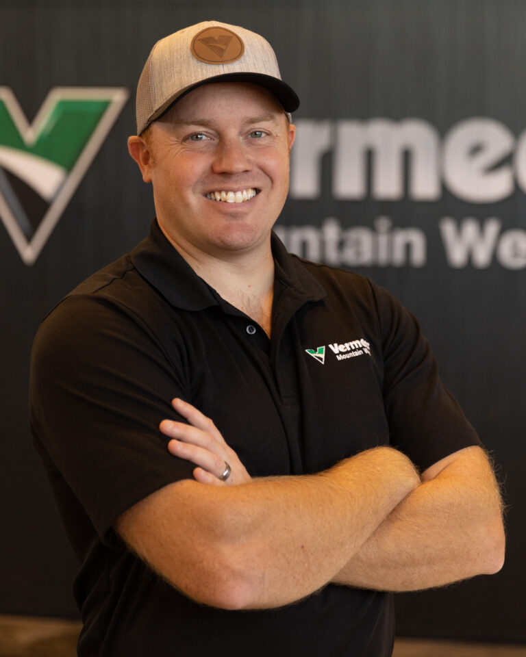 Blake Arnold, Vermeer Underground Sales Representative, standing in front of Vermeer backdrop.