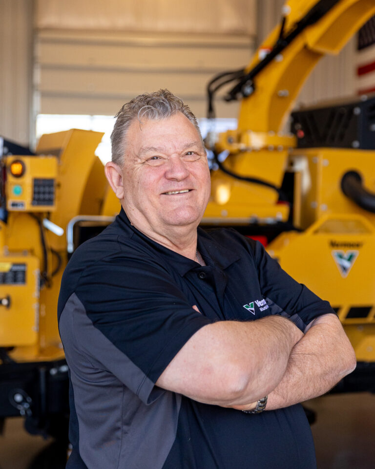 Gordon Lawes, Vermeer Environmental Sales Representative, standing in front of Vermeer machinery.