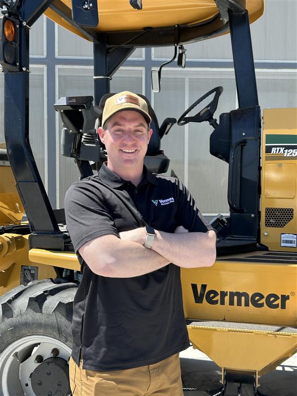 Jacob Sherman, Vermeer Environmental Sales Representative, standing in front of Vermeer machinery.