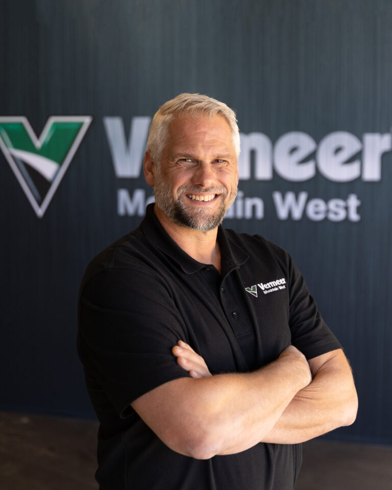 Jerry Werkhoven, Vermeer Environmental Sales Representative, standing in front of Vermeer machinery.