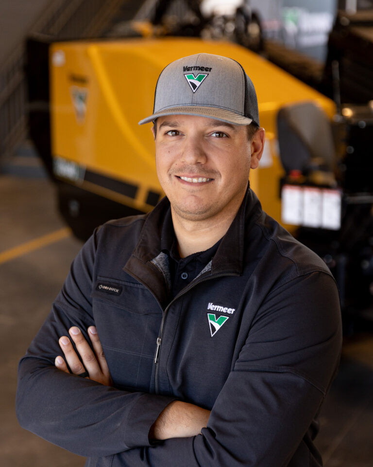 Justin Johnson, Vermeer sales representative, standing in front of a Vermeer Directional Drill.