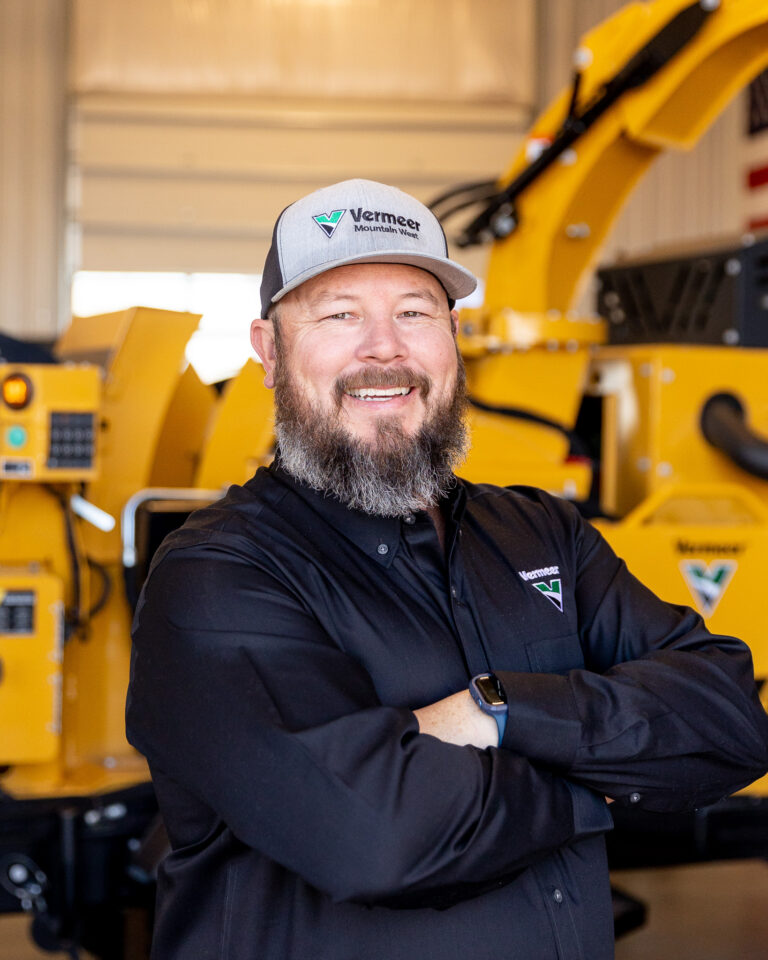 Scott Smith, Vermeer Underground Sales Representative, standing in front of Vermeer machinery.