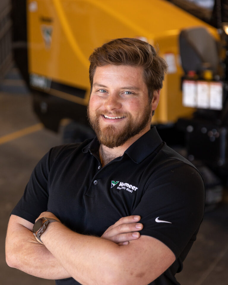 Shane Newsom, Vermeer Equipment Sales Representative, standing in front of Vermeer machinery.