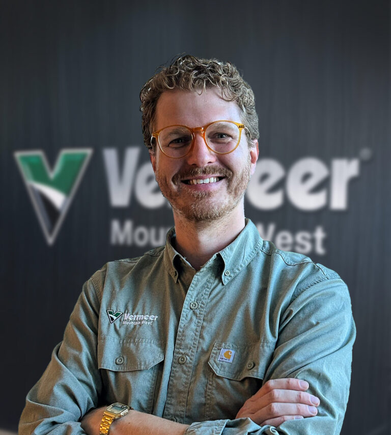 John Kelley, Vermeer Mountain West Marketing Manager, standing arms crossed in front of a black Mountain West background.