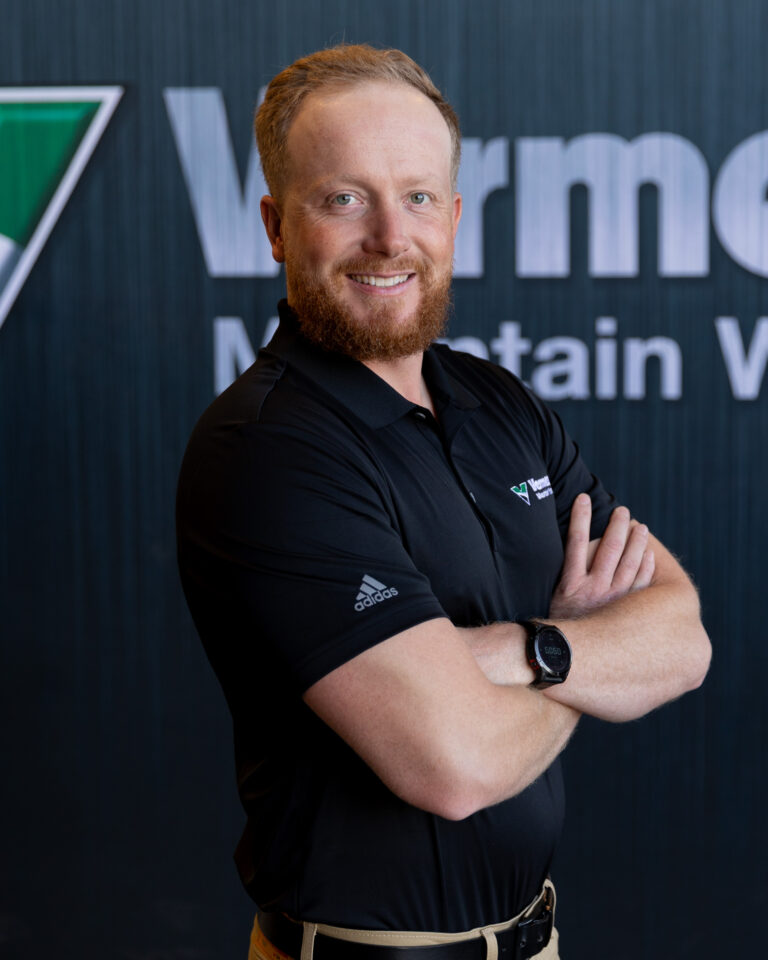 Luke Holding, Vermeer Branch Manager, standing in front of a black backdrop with the Vermeer logo.