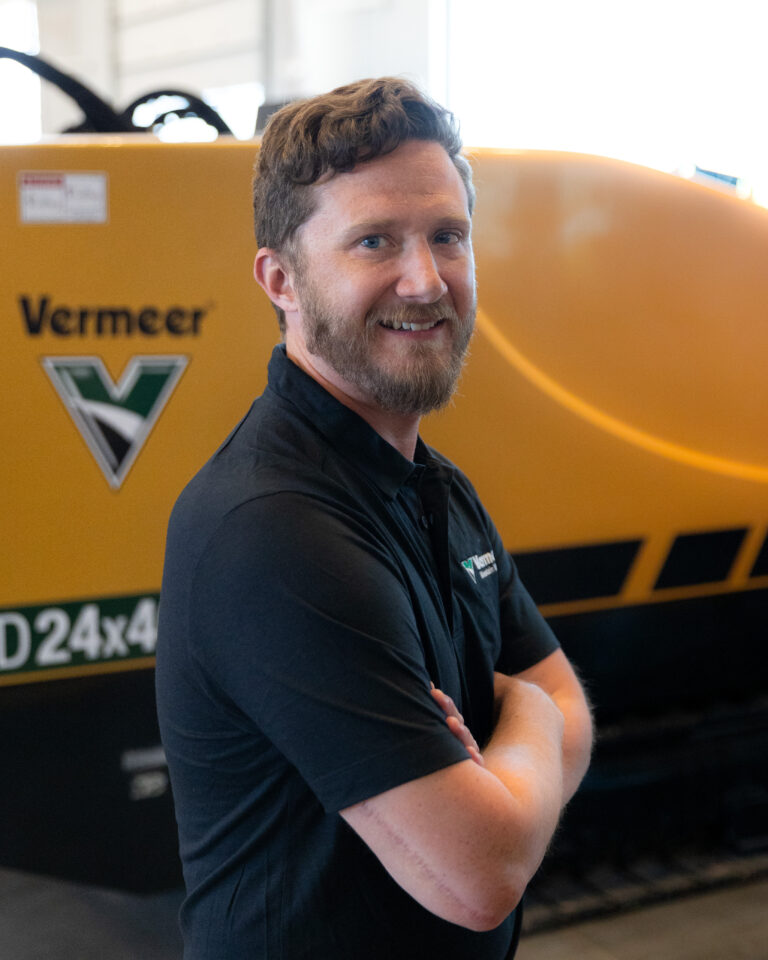 Rudy Godfrey, Vermeer Branch Manager, standing in front of a Vermeer machine.